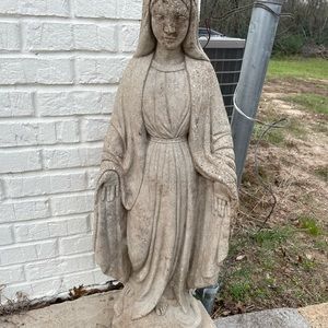 The statue is a woman standing on a snake, the woman resembling protection.